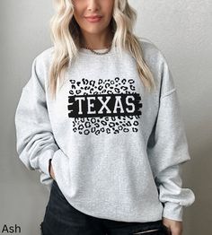 Texas Sweatshirt, Texas Crewneck, Austin Texas, Preppy Sweatshirt, State Trendy Sweatshirt, Aesthetic Sweatshirt, Cheetah Texas Sweatshirt Our shirts are made to order specially for you. Because of this reason we don't accept returns or exchanges. Please check our color and size charts before you place your order. If you have any questions please send us a message to clarify sizing or colors. Ideal for any situation, a unisex heavy blend crewneck sweatshirt is pure comfort. These garments are made from polyester and cotton. This combination helps designs come out looking fresh and beautiful. The collar is ribbed knit, so it retains its shape even after washing. There are no itchy side seams on these sweaters. ✨ Gildan Brand ✨ 50% cotton, 50% polyester ✨ Medium-heavy fabric 8.0 oz ✨ Loose f Fall Leopard Print Tops With Letter Design, Fall Leopard Print Top With Letter Details, Casual Leopard Print Sweater, Texas Sweatshirt, Preppy Sweatshirts, Texas Shirt, Aesthetic Sweatshirt, Sweatshirt Aesthetic, Texas Shirts