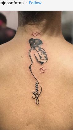 a woman's back with a tattoo on her neck and the word love written in cursive writing