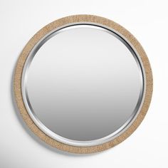 a round mirror hanging on the wall