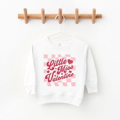 Looking for a cute sweatshirt for your kids? We have the perfect Checkered Little Miss Valentine graphic sweatshirt addition to their closet! Also available in youth sweatshirts. Playful White Long Sleeve Sweatshirt, Playful White Sweatshirt For Fall, Cute Sweatshirt With Text Print And Long Sleeves, Cute Long Sleeve Sweatshirt With Text Print, Cute Crew Neck Sweatshirt For School, Playful Letter Print Sweatshirt For Fall, Playful White Cotton Sweatshirt, Cute White Sweatshirt For School, Cute White School Sweatshirt