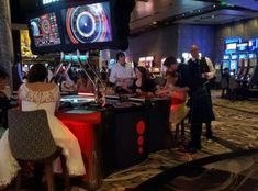 people are sitting at tables in a casino