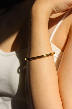 PRODUCT DESCRIPTION Golden simplicity. This piece is a minimalist statement piece for any look. The Ava Plain bangle celebrates the beauty of expert craftsmanship. Formed from polished titanium steel and coated with gleaming 18-karat gold for an opulent finish, this bangle adds a suave touch to your wrist – whether worn alone or stacked alongside your favourite timepiece. A must-have addition to your jewellery addition. Signature Gold Bangle Water Resistant 18k Gold-plated on titanium steel One Everyday Tarnish Resistant Cuff Bangle, Everyday Gold Timeless Cuff Bracelet, Timeless Gold Cuff Bracelet For Everyday Wear, Modern Gold Bracelet, Tarnish Resistant For Everyday Luxury, Modern Tarnish-resistant Gold Bracelet For Everyday Luxury, Everyday Polished Yellow Gold Cuff Bracelet, Modern Matte Gold Bracelet For Formal Occasions, Modern Gold Bracelet For Formal Occasions, Modern Matte Gold Bracelets For Formal Occasions