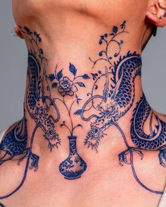 a woman with a blue dragon tattoo on her neck and neck piece in the shape of a vase