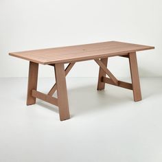 a wooden table sitting on top of a white floor