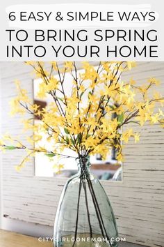 a vase filled with yellow flowers on top of a wooden table