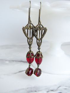 "These statement dangle earrings are made with beautiful brass filigree, Czech glass beads, and small square vintage glass stones from the 1960s. The glass beads are a rich red with a pebble finish. The brass stampings have been hand-patinaed by me.  These earrings are 3\" long from the top of the earring hook to the bottom of the dangles. Without the hook, they are 2.25\" long. ------------------- **Please be sure to read my shipping and store policies, and don't hesitate to send me a message w Vintage Czech Glass Matching Earrings, Vintage Red Brass Earrings, Vintage Red Czech Glass Jewelry, Brass Filigree, Gold Earrings Designs, Le Crochet, Brass Earrings, The Hook, Czech Glass Beads