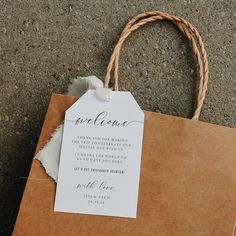 a brown paper bag with a white tag on it that says welcome to the bride