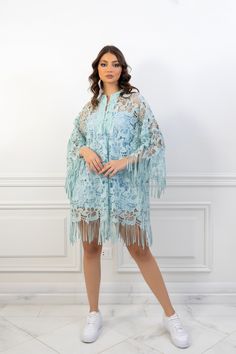 (SALE ITEM - FINAL SALE)Featuring: Floral Lace Fringe sleeves Unlined Bell sleeves Band collar Color: Tiffany blue.Brand: Unmatched BYU.Match it with a slip dress - The model is wearing a baby blue mini slip dress (Shop slip dresses)Size: Free Size. "fits sizes between 2 (US) up to 24 (US)"Exact Caftan Measurements: Bust: 52 (Inches)Hem: 63 (Inches)Length: 32.5 (Inches)This caftan is available in multiple colors Spring Beach Cover-up Dress With Tassels, Elegant Long Sleeve Kaftan With Tassels, Evening Kaftan With Tassels, Bohemian Long Sleeve Party Cover-up, Spring Kaftan With Tassels And Kimono Sleeves, Elegant Long Sleeve Dress For Beach Cover-up, Long Evening Kaftan For Spring, Long Kaftan For Spring Evening, Spring Party Long Sleeve Cover-up