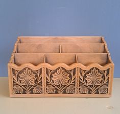 a wooden box with four compartments sitting on a table