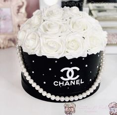 a black and white chanel box with roses in it