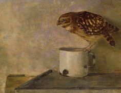 an owl is perched on top of a cup