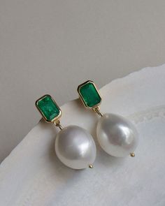 These earrings feature one-of-a-kind baroque pearls and Zambian emeralds. Baroque pearls are naturally formed and each is unique. Our emeralds are 100% natural, meaning they're not dyed or heat treated. No stone is exactly alike. 14k solid gold—always. Weight: 3g per earring Carat weight: 0.5cw per earring Stone Measurements: 6mm x 4mm Pearl Measurements: Approx 13mm x 12mm Pearl & Emerald Care: Pearls and emeralds are not meant to be worn in the shower. To extend the life of your piece, we reco Pearl Emerald Earrings, Green Emerald Earrings With Pearl Drop, Elegant Green Pearl Earrings With Charm, Elegant Green Pearl Charm Earrings, Emerald Earrings With Pearl Drop For Gift, Green Gemstone Pearl Drop Earrings, Green Pearl Drop Earrings, Green Gemstone Drop Pearl Earrings, Pearl Drop Earrings For May Birthstone