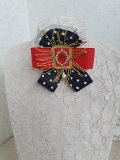 Red, black and gold bowtie brooch, Grosgrain ribbon bow tie broach, Stripped ribbon bow brooch, Modern brooch, Everyday fashion Beautiful gift for girlfriend, women, wife, mother or daughter on Christmas or any other occasion. This handmade bow tie can be worn on a shirt, a dress, a sweater, a t-shirt or as an accessory for coat, bag or everything is allowed to be attached by a brooch or alligator clip 3 7/8 inch lengths 4 inch width Ready for shipping My Flower accessories are carefully packed Black Brooch With Decorative Bow Gift, Black Brooch With Decorative Bow As Gift, Black Ribbon Brooches For Gift, Black Ribbon Brooches As Gift, Vintage Bow Tie Brooch As Gift, Elegant Red Pins For Party, Elegant Red Party Pins, Vintage Ribbon Brooches As Gift, Black Brooch With Decorative Bow For Evening