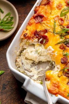 a casserole dish with bacon, cheese and green beans in it on a wooden table