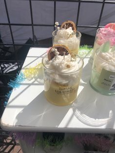 three desserts sitting on top of a white table next to each other in small cups