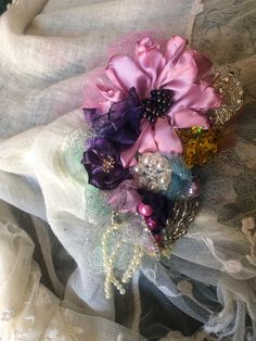 a close up of a cloth with flowers and pearls on it's headband