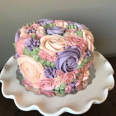 there is a cake that has flowers on the top and bottom of it, sitting on a platter