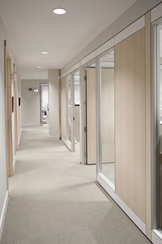 an empty hallway with sliding glass doors on both sides