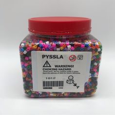 a jar filled with lots of colorful beads