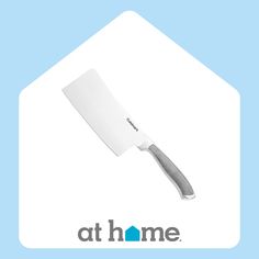 a large white knife on top of a blue background with the words at home above it