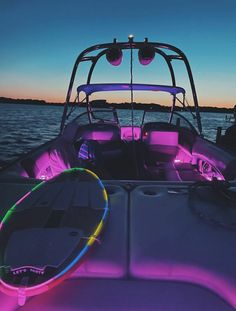 the inside of a boat that is lit up with neon lights