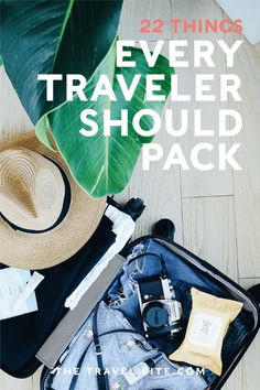 an open suitcase with clothing and hat on the floor next to a large green leaf that says, 22 things every traveler should pack