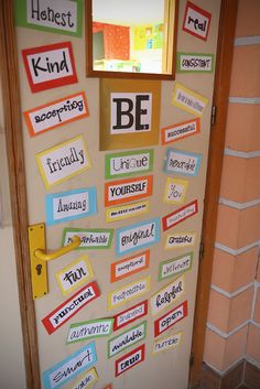 a bulletin board that has been decorated with different types of stickers and words on it