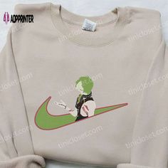 a white sweatshirt with a green nike logo on it