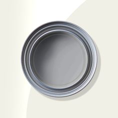 a close up of a paint can on a white wall with a gray tint