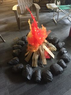 a bunch of trash bags sitting on the floor in front of a fire pit with lights