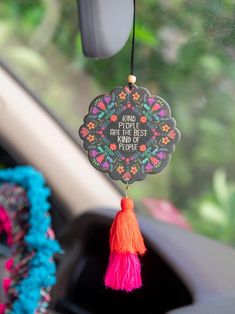 a car dashboard with a colorful decoration hanging from it's side