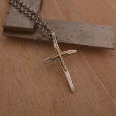 Because you've got to have faith. In the hustle and bustle of life, this stunning sterling silver and K14 gold cross necklace serves as a fitting reminder of what is important in life. Suspended from a sterling silver chain or black leather cord, it features a luminous sterling silver cross with a second smaller 14KT gold cross draped along the front. Wear it every day to uplift your spirits and share your faith with those whose path you cross. This is an original City Lights Jewellery creation. Gold Necklace With Oxidized Cross Pendant, Gold Cross Necklace With Oxidized Finish, Gold Cross Jewelry With Oxidized Finish, Gold Oxidized Cross Jewelry, Light Jewelry, Gold Cross Necklace, Gold Cross, Sterling Silver Cross, Silver Cross