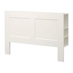 a white headboard with two open shelves on each side and one closed shelf at the top