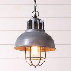 an industrial style light hanging from a chain