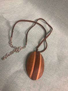 Turned wooden pendant Brown Wooden Pendant Jewelry, Wooden Pendant Necklace For Gift, Brown Necklace With Large Pendant For Gift, Brown Necklace With Large Pendant As Gift, Brown Pendant Necklace With Large Pendant, Brown Necklace With Large Round Pendant, Brown Wooden Necklace Gift, Brown Wooden Necklace For Gifts, Brown Wooden Necklace For Gift