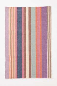 a multicolored striped rug on a white background