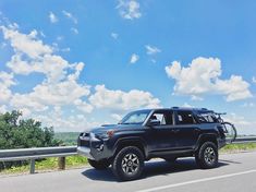 a black toyota truck driving down the road