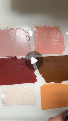 someone is painting different shades of red and brown