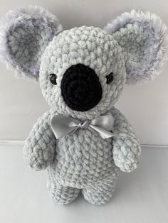 a crocheted koala bear with a bow tie