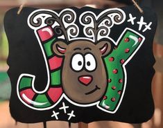 a black sign with a reindeer head and letter j on it