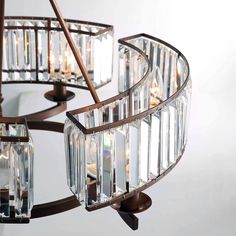 a chandelier hanging from the ceiling with clear glass blocks on it's sides