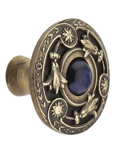 an antique style door knob with a blue stone in the center and flowers on it