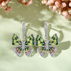 Add sparkle to your look with these butterfly-inspired earrings. Beautiful enamel design with vibrant colours and wings that'll define the Spirit of You. This intricate design is handcrafted using the legendary art of enameling, with sparkling stones that recreate the charm of the butterfly. Inspired by the beauty of nature, this will brighten up even the dullest of days in your life. Vibrant and full of life, these beautiful butterflies are ready to land in your jewelry box.Carat Weight: 0.49 c Butterfly Charm Earrings As Gift, Butterfly Charm Wing-shaped Earrings For Gift, Multicolor Butterfly Charm Earrings, Multicolor Butterfly Charm Earrings As Gift, Multicolor Butterfly Earrings, Multicolor Butterfly Print Jewelry Gift, Hand Painted Butterfly Jewelry Gift, Hand Painted Butterfly Jewelry For Gift, Mystical Butterfly