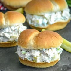 several small sandwiches with chicken salad on them