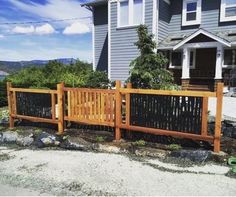 a wooden fence in front of a house