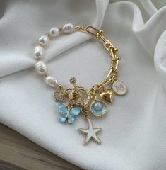 Elevate your jewelry collection with this elegant natural stone bracelet, featuring a 10mm real water pearl and six unique charms. The bracelet is secured with a special lock system, combining beauty and functionality for everyday wear or special occasions. 🌿 10mm real water pearl as the centerpiece for a timeless, classic look ✨ Includes 6 natural stone charms for a unique, nature-inspired design 🗝️ Special lock system ensures security and ease of wear High-quality materials crafted for durab Unique Nature, Love Natural, Natural Stone Bracelets, Nature Inspired Design, Real Stone, Water Pearls, Pearl Charms, Butterfly Charm, Elegant Accessories