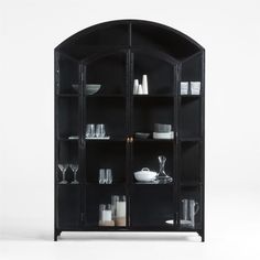 a black bookcase with glass doors and shelves