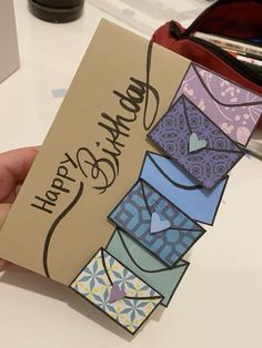 a hand holding up a card that says happy birthday