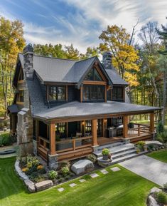 a large house in the middle of a forest with lots of green grass and trees