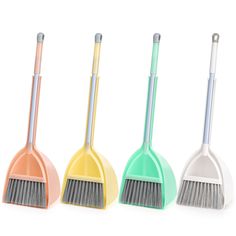 three different colored brooms and one with a long bristles on each side, all lined up in the same row